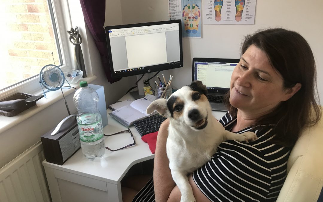 Nita with her dog whilst they are working from home
