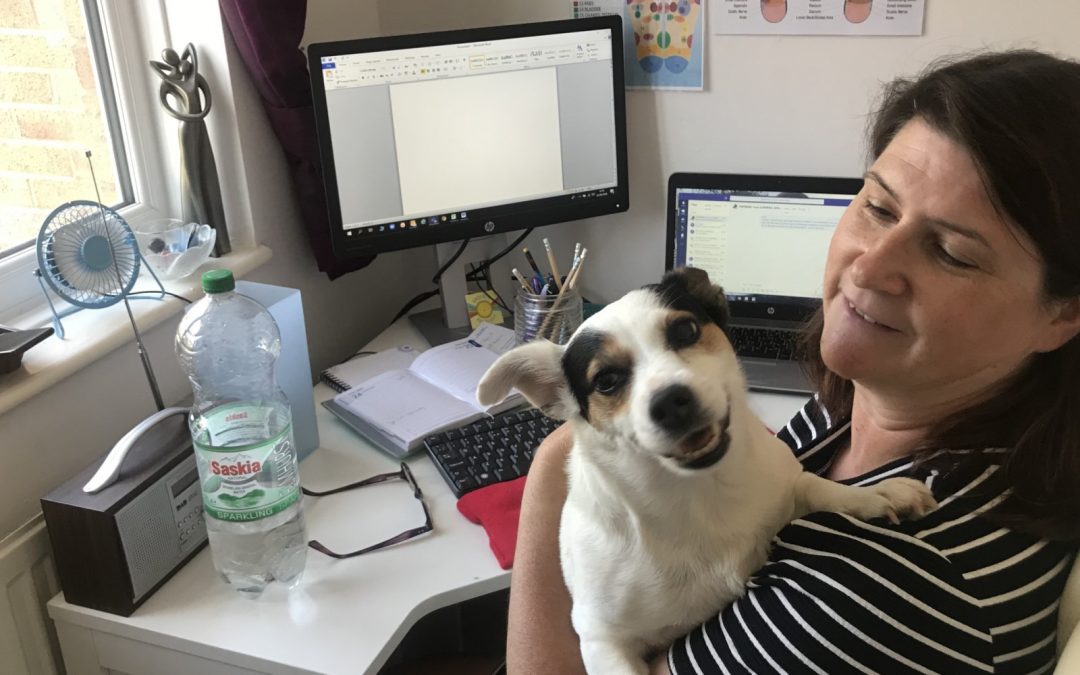 Nita with her dog whilst they are working from home