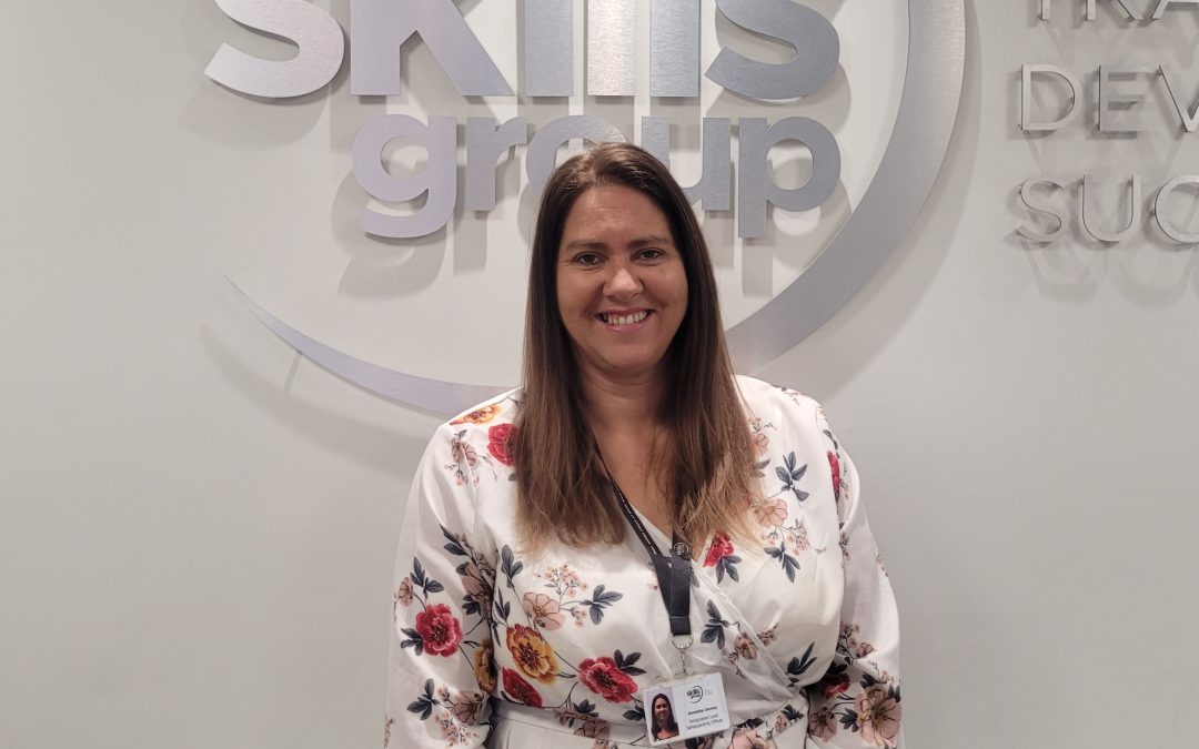 Person in front of Skills Group logo
